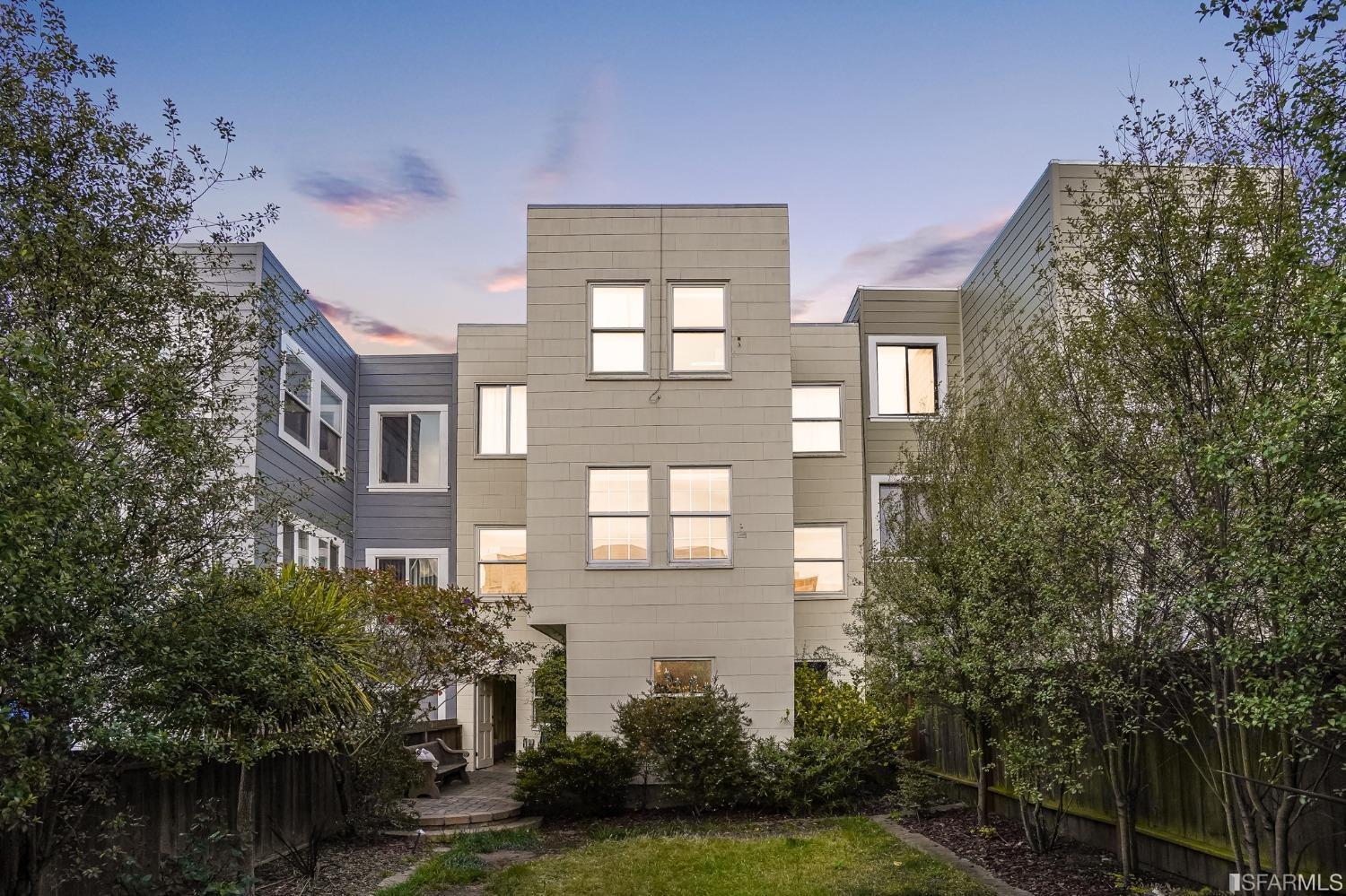 a front view of a residential apartment building with a yard