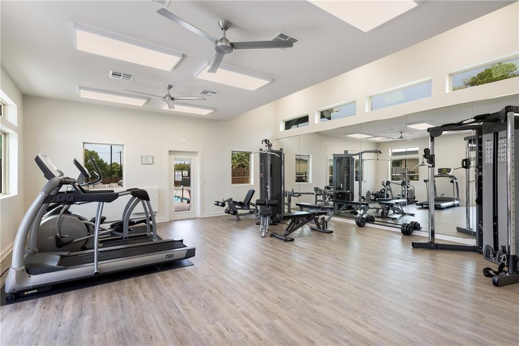 7805 Cooper Lane, Unit 606 Austin, TX 78745 - Photo 30 of 35 a living room with furniture gym equipment and a wooden floor