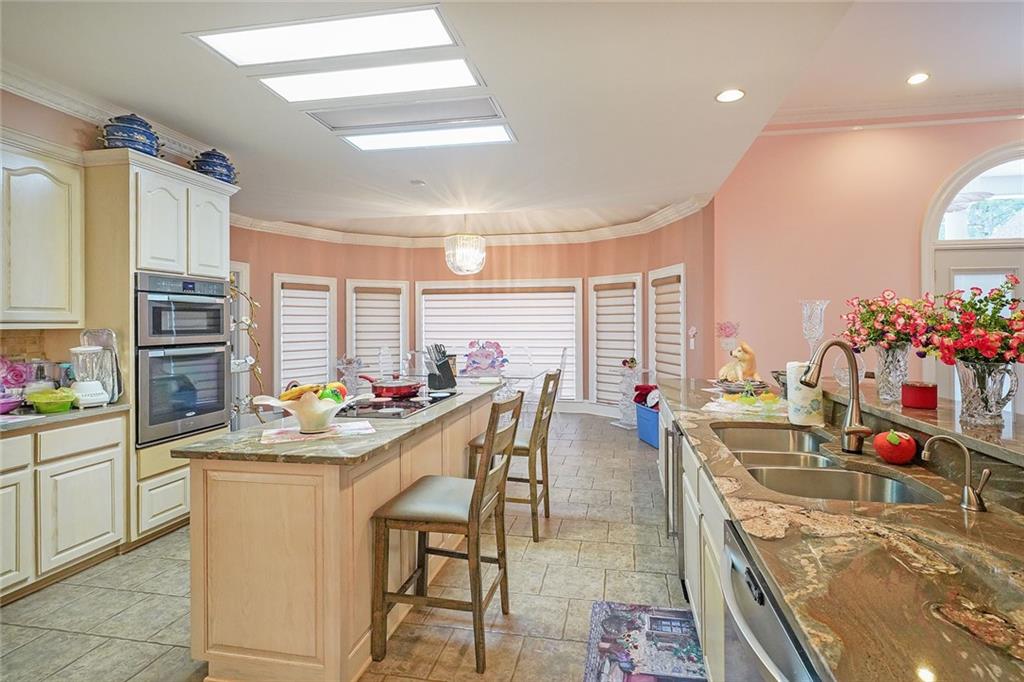 1827 Poplar Springs Road Hiram, GA 30141 - Photo 15 of 45 a room with stainless steel appliances kitchen island granite countertop a sink and cabinets