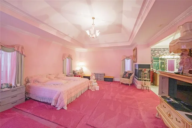 a bedroom with furniture and a chandelier