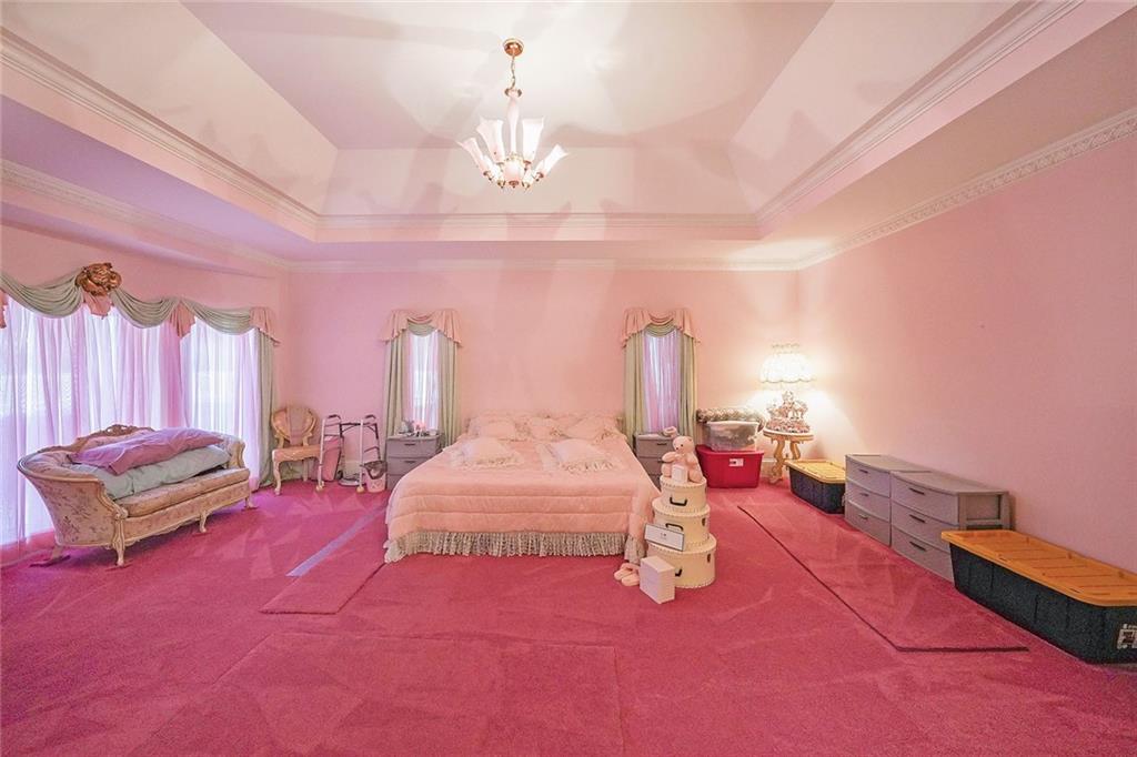 1827 Poplar Springs Road Hiram, GA 30141 - Photo 24 of 45 a bedroom with furniture and a chandelier