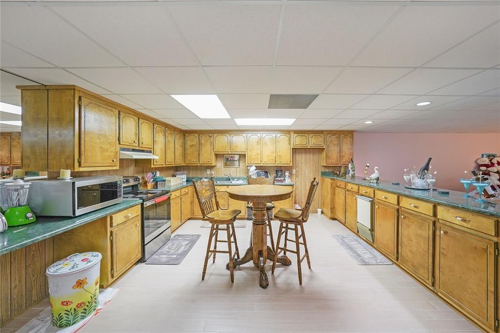 1827 Poplar Springs Road Hiram, GA 30141 - Photo 30 of 45 a kitchen with stainless steel appliances granite countertop table chairs sink and cabinets