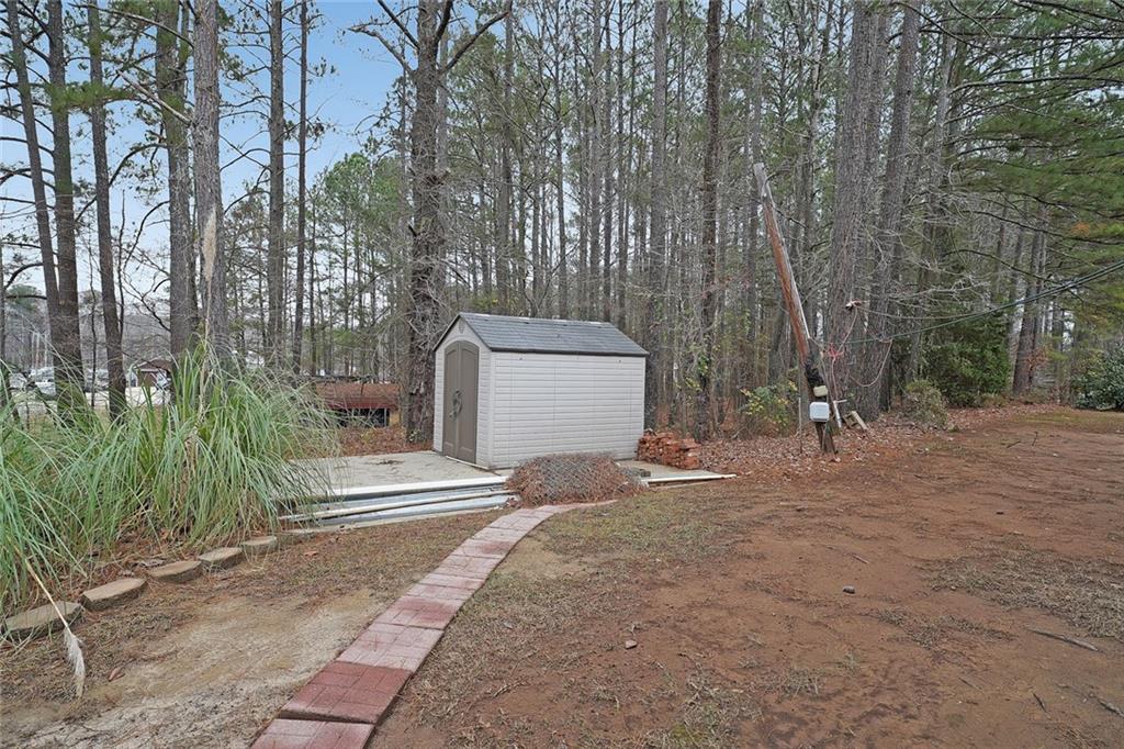 1827 Poplar Springs Road Hiram, GA 30141 - Photo 38 of 45 a backyard of a house with fountain and trees