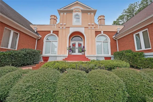 a front view of a house with garden