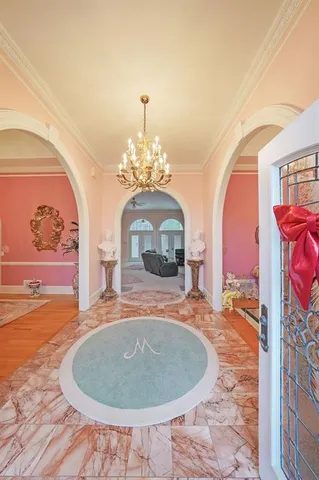 a bed room with a bed and a chandelier