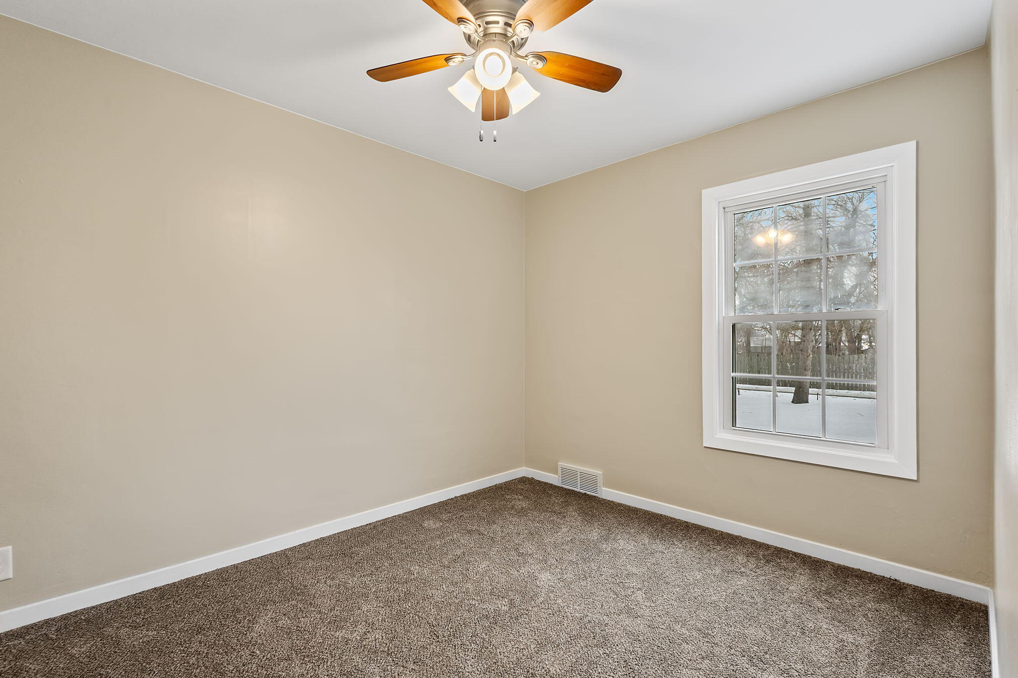 314 Cline Avenue Griffith, IN 46319 - Photo 16 of 36 an empty room with a window and a fan
