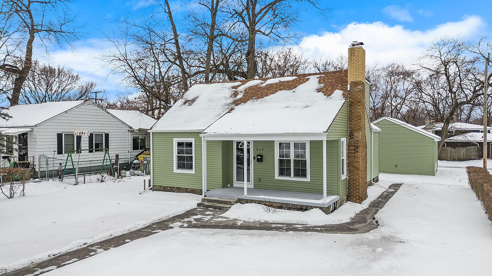 314 Cline Avenue Griffith, IN 46319 - Photo 33 of 36 a view of a white house with a large windows and a table and chairs in patio