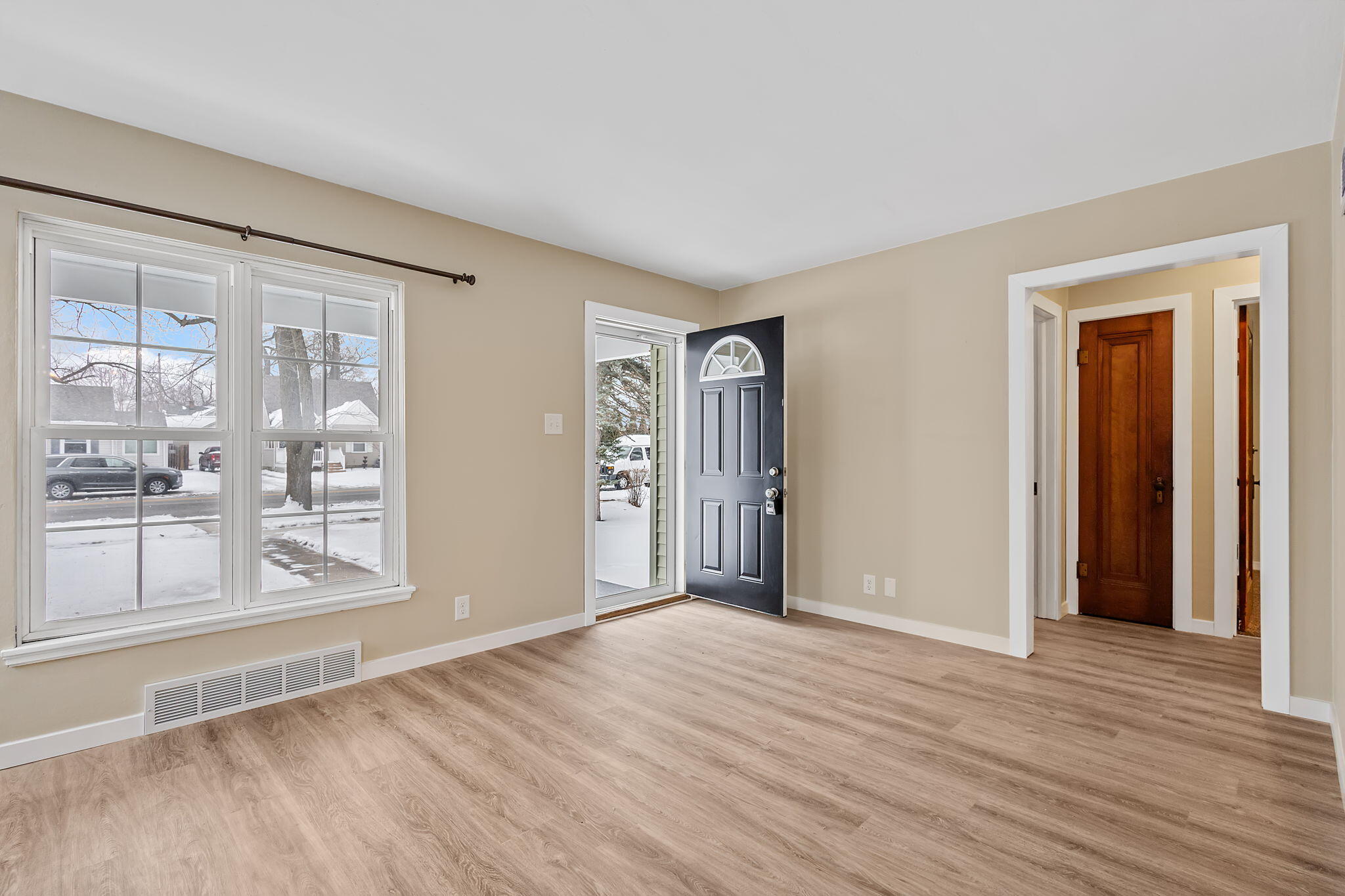 314 Cline Avenue Griffith, IN 46319 - Photo 4 of 36 a view of an empty room with wooden floor and a window