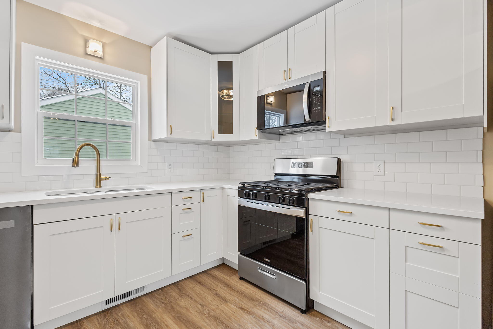 314 Cline Avenue Griffith, IN 46319 - Photo 7 of 36 a kitchen with white cabinets stainless steel appliances and sink