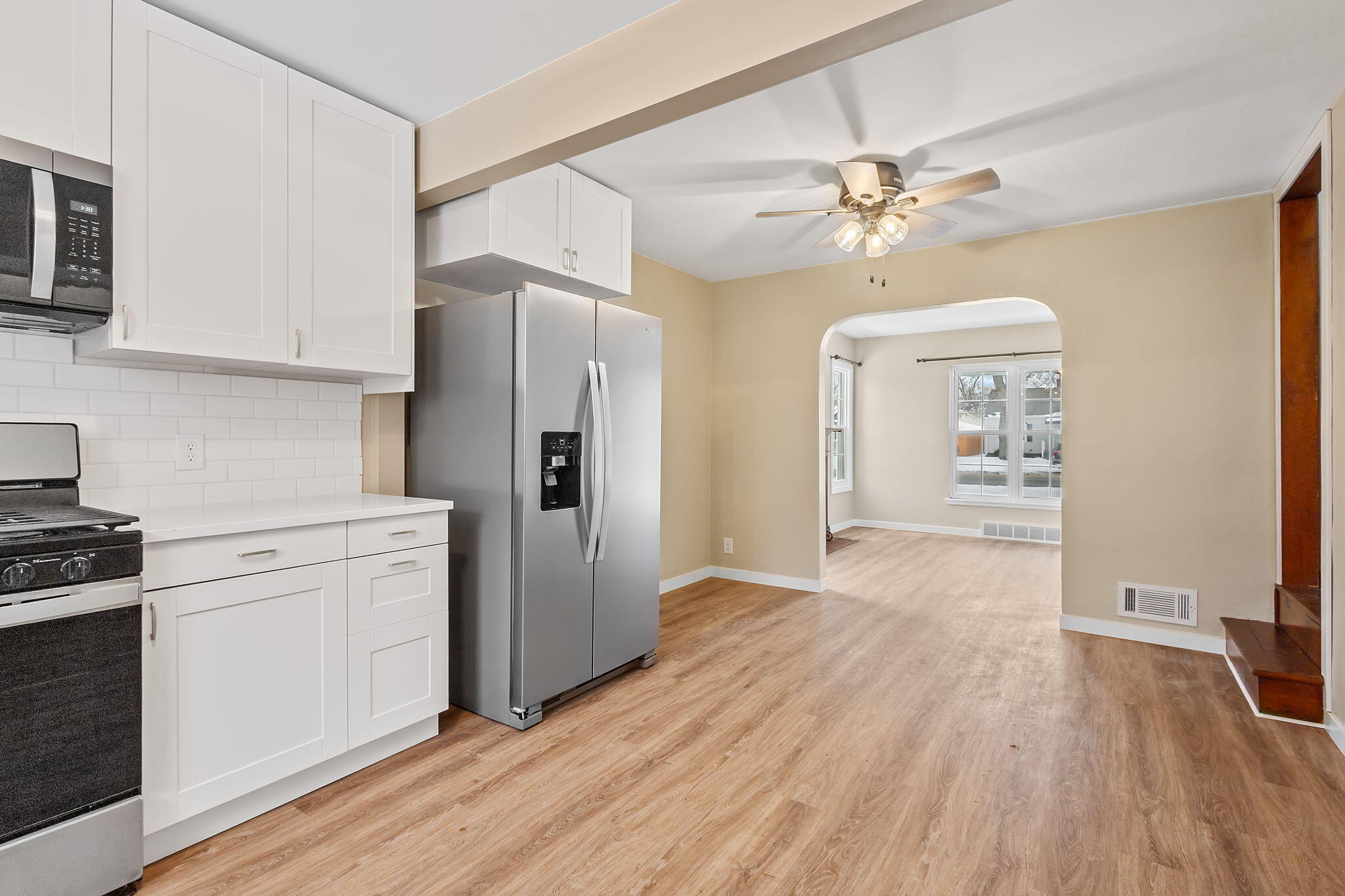 314 Cline Avenue Griffith, IN 46319 - Photo 10 of 36 a kitchen with kitchen island white cabinets and stainless steel appliances