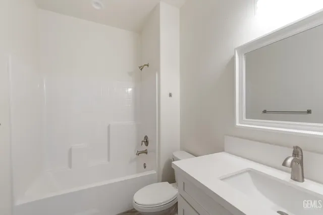 a bathroom with a sink toilet vanity and shower