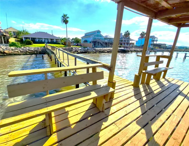 a view of a swimming pool with outdoor seating and swimming pool