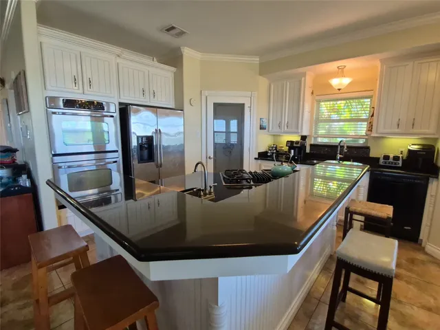 a kitchen with a stove a sink and a refrigerator