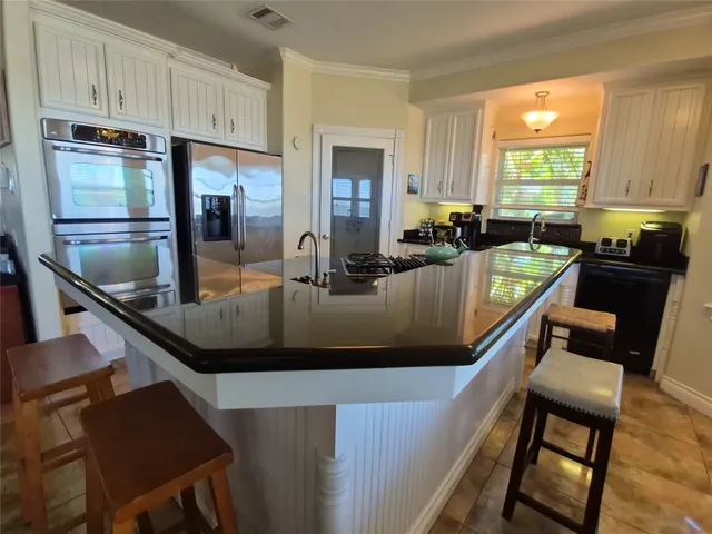 a spacious bedroom with a bed and a chandelier
