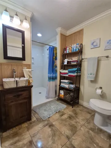 a view of a house that has a table and chair in the patio