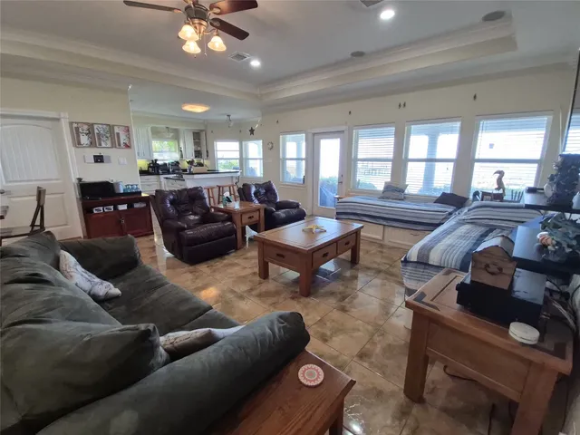 a living room with furniture and a chandelier