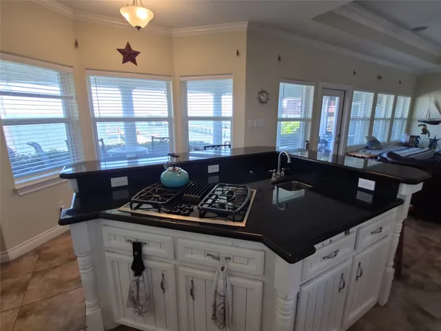 a kitchen with granite countertop a sink and a stove