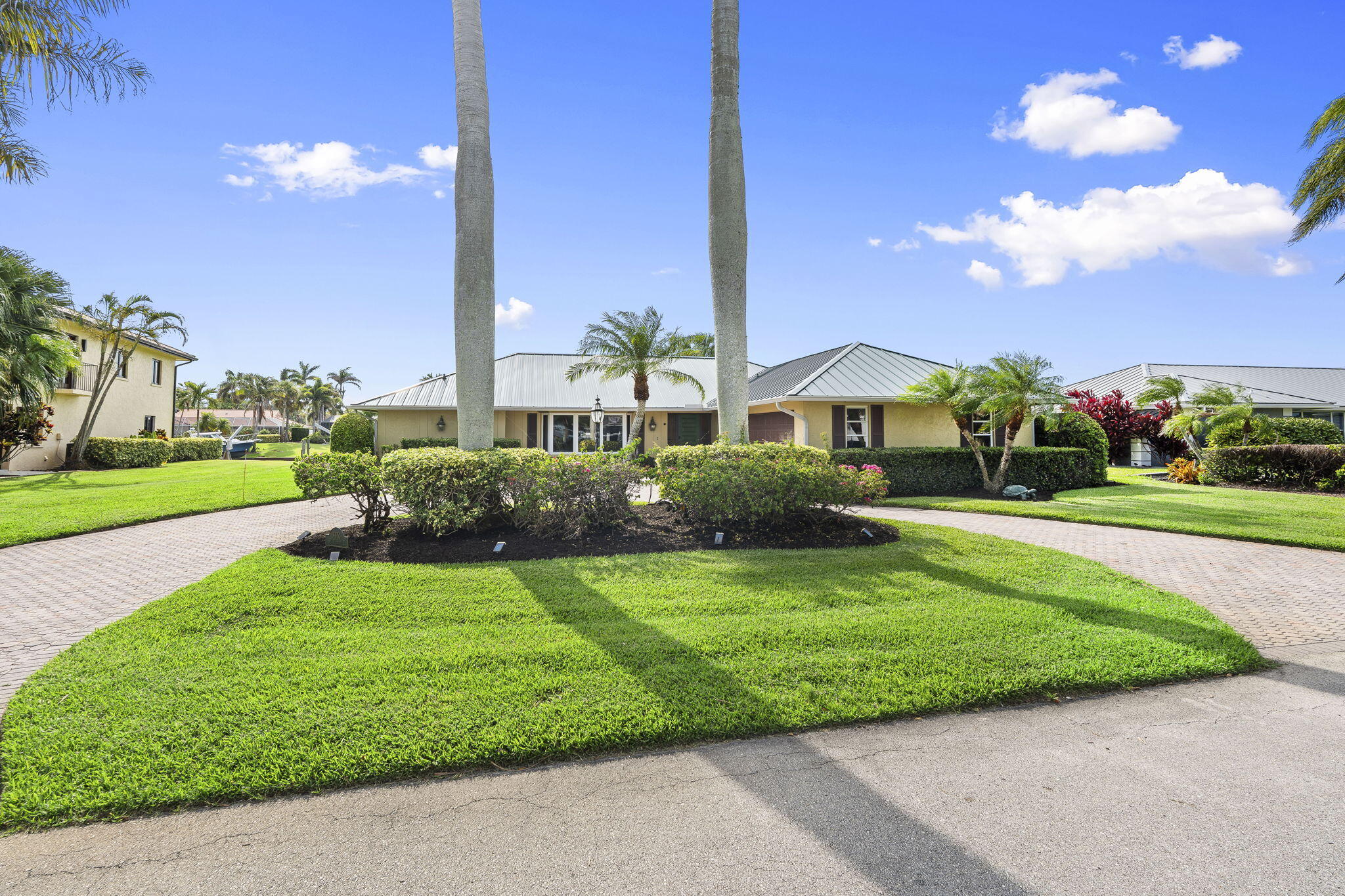 3374 Southeast Fairway East Stuart, FL 34997 - Photo 6 of 65 a front view of a house with yard and green space