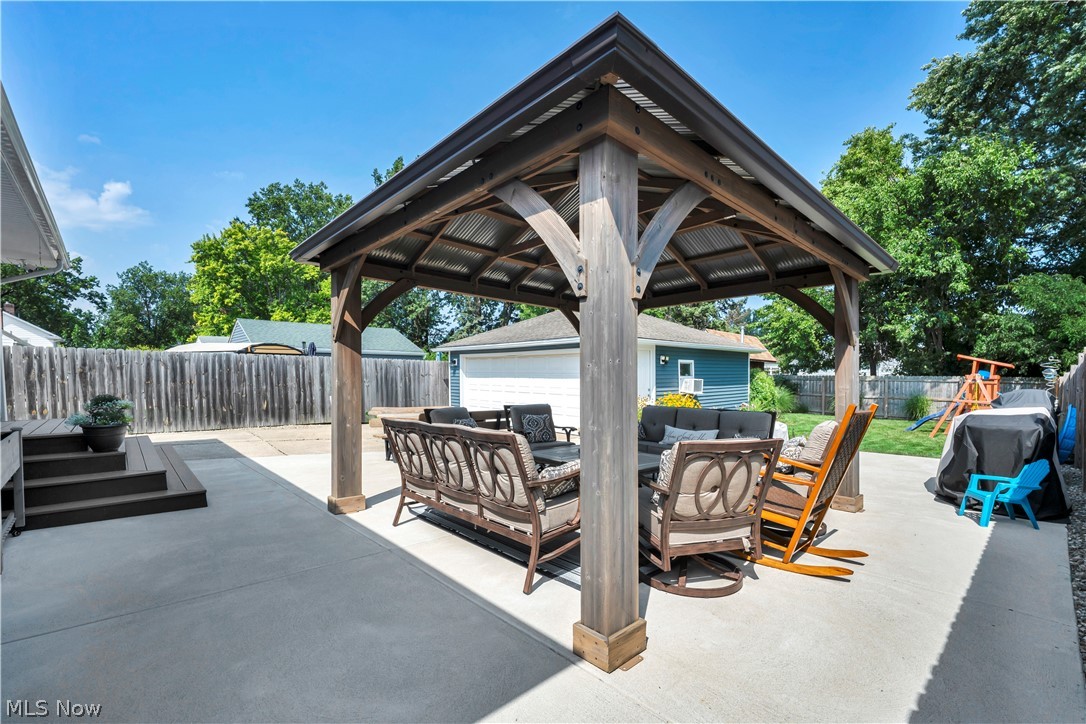 977 Lloyd Road Wickliffe, OH 44092 - Photo 34 of 38 Expansive concrete patio with a permanent gazebo structure, wood privacy fencing, and blue exterior siding