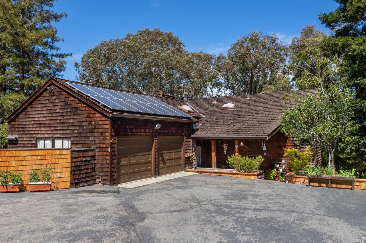 a view of a house with a yard and garage
