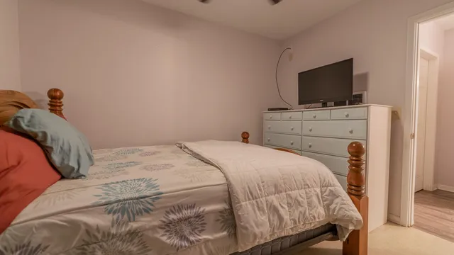 a bedroom with a bed and a flat screen tv
