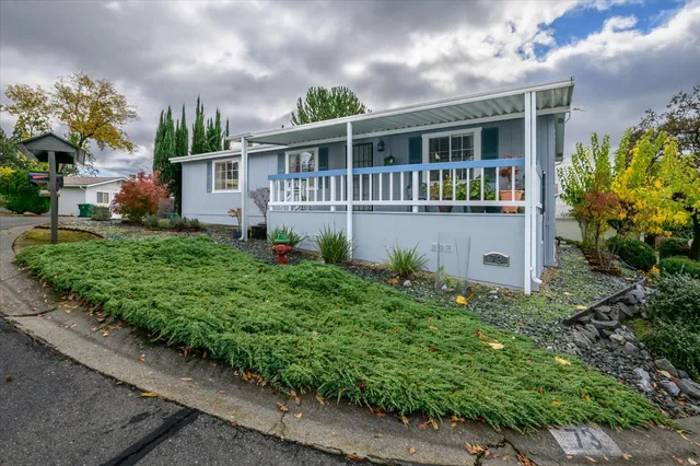a house with green field in front of it