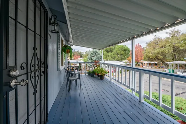 a view of a chairs and table in the balcony