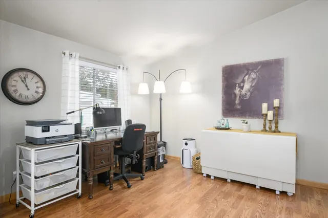 a view of a workspace with furniture and a window