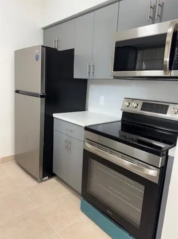 a kitchen with a stove and a microwave