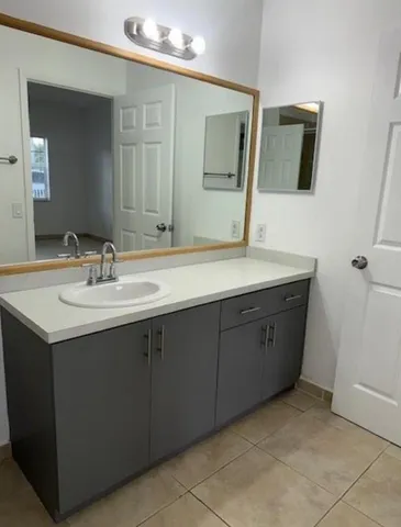 a bathroom with a sink and a mirror