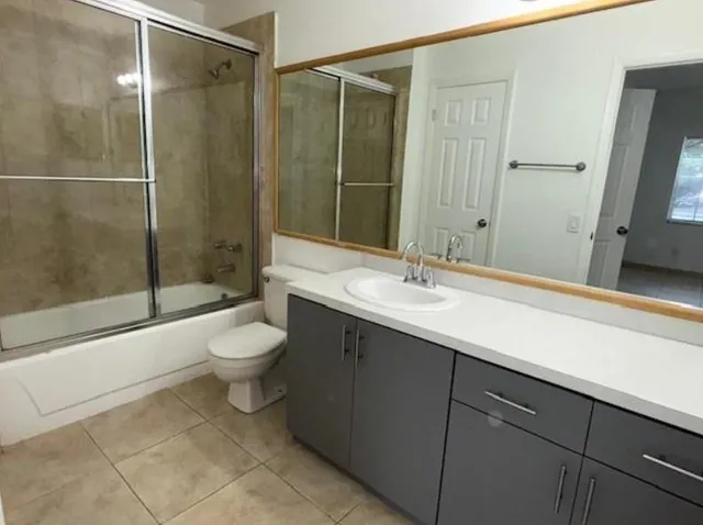 a bathroom with a sink shower and a toilet