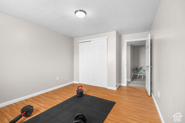 1045 West 3600th South Perry, UT 84302 - Photo 44 of 57 Smooth wall finish, wood-finish flooring, white trim, sliding closet doors, and recessed lighting