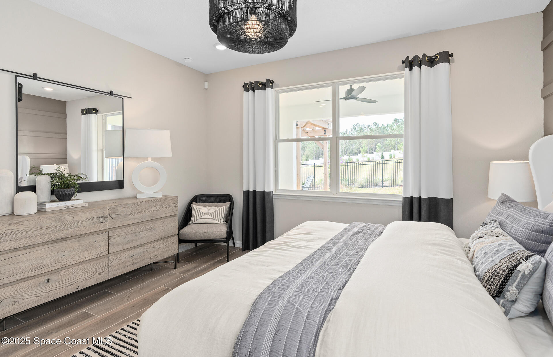 3494 Bubbles Court Melbourne, FL 32901 - Photo 20 of 22 a bedroom with a bed and a large window