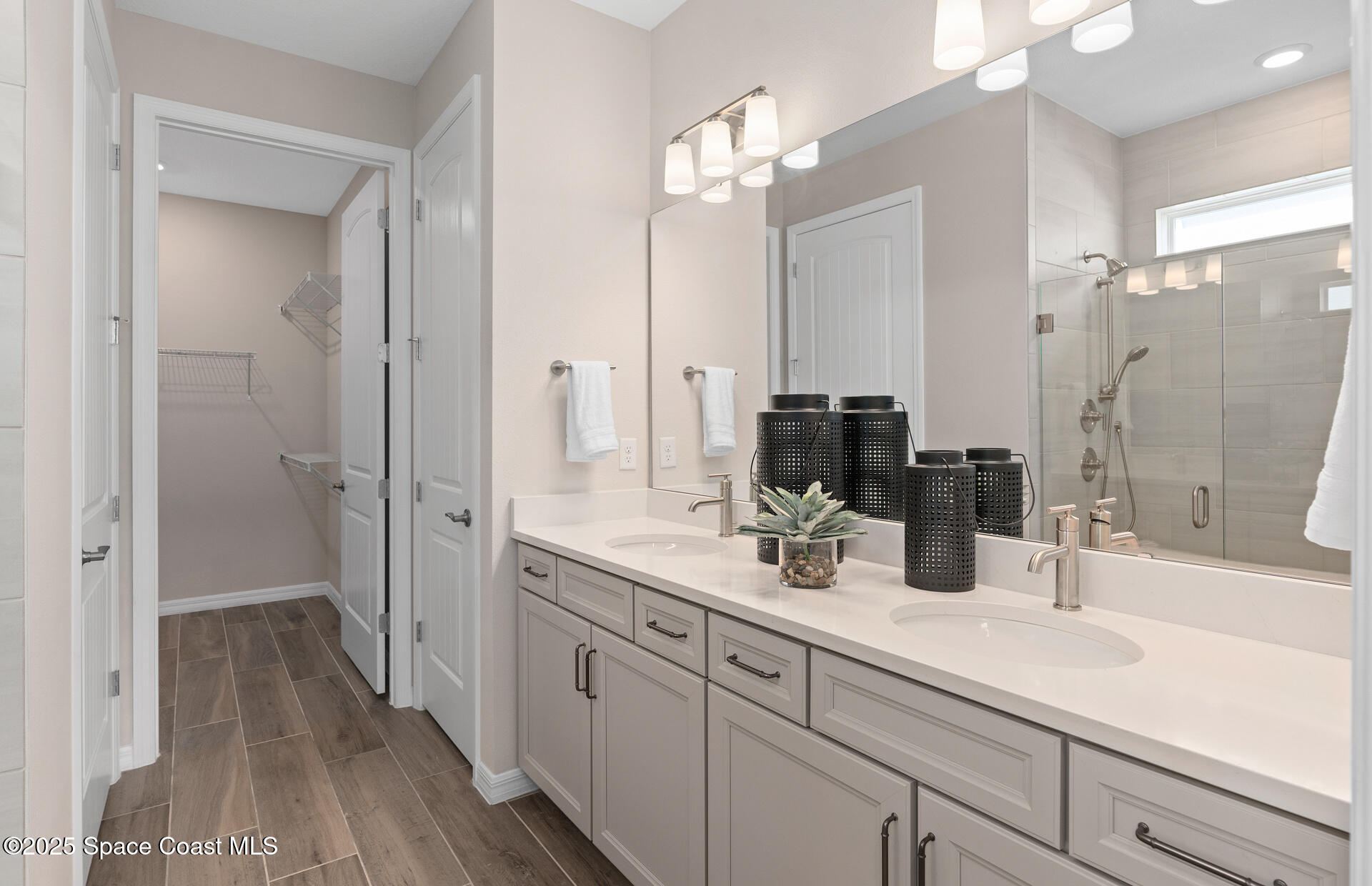 3494 Bubbles Court Melbourne, FL 32901 - Photo 21 of 22 a bathroom with a sink a mirror a vanity and shower