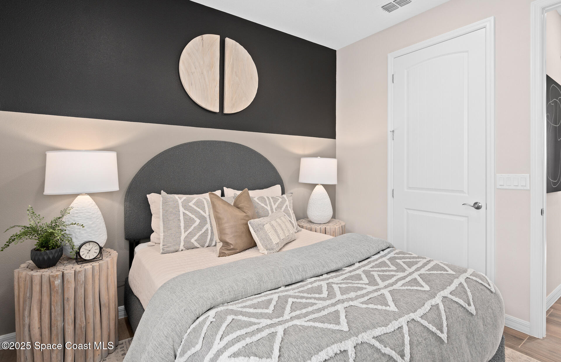 3494 Bubbles Court Melbourne, FL 32901 - Photo 5 of 22 a bedroom with a bed and a mirror