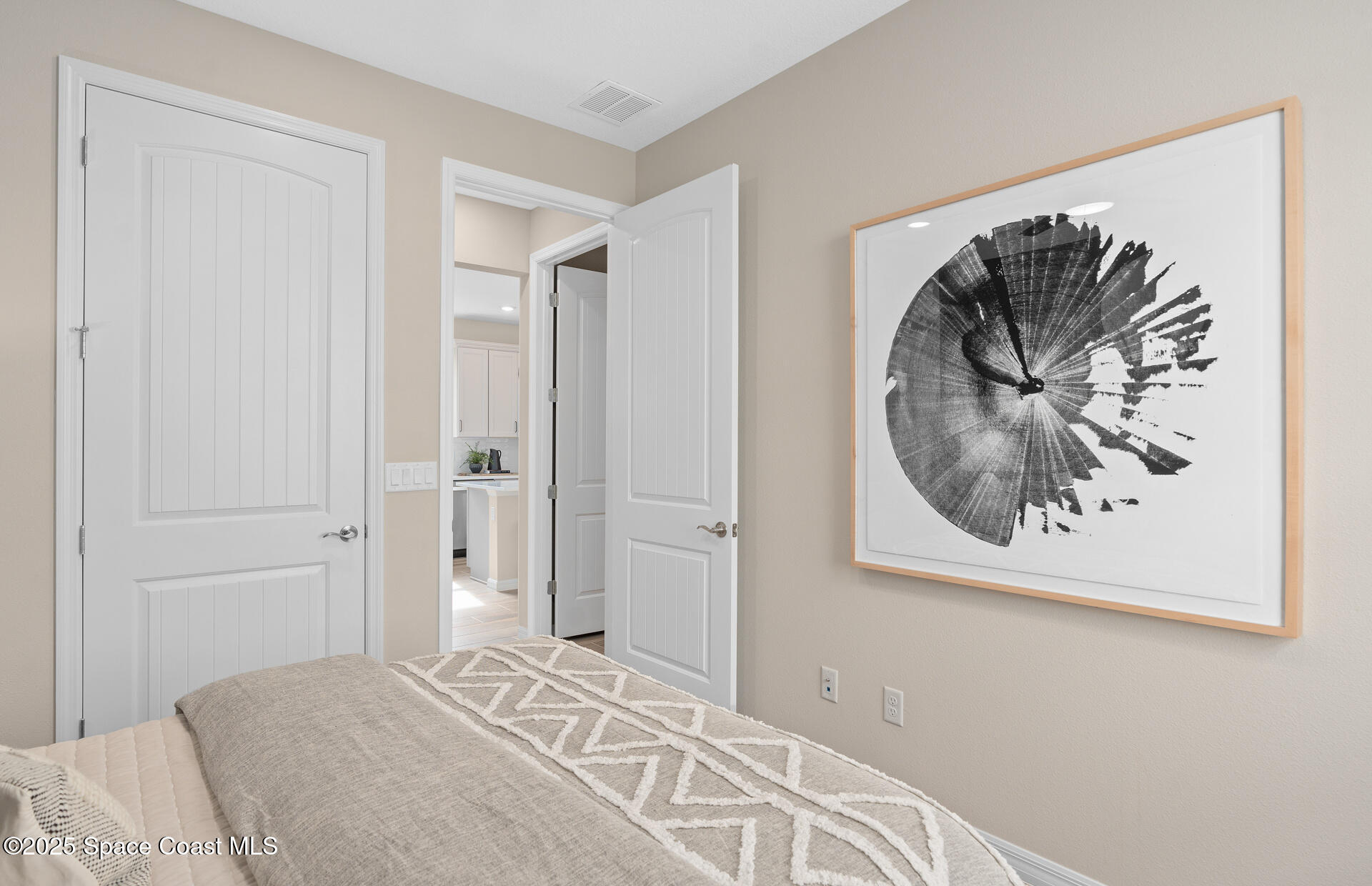 3494 Bubbles Court Melbourne, FL 32901 - Photo 6 of 22 a bedroom with a bed and a painting on the wall