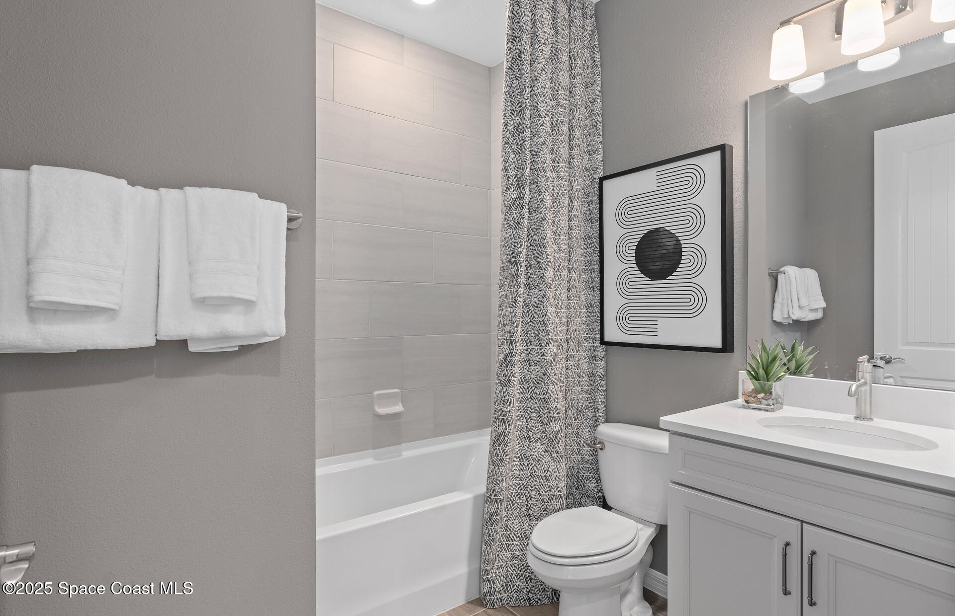 3494 Bubbles Court Melbourne, FL 32901 - Photo 7 of 22 a bathroom with a sink toilet and shower