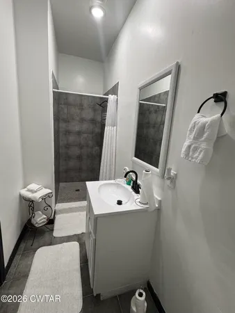 a bathroom with a toilet a sink and shower