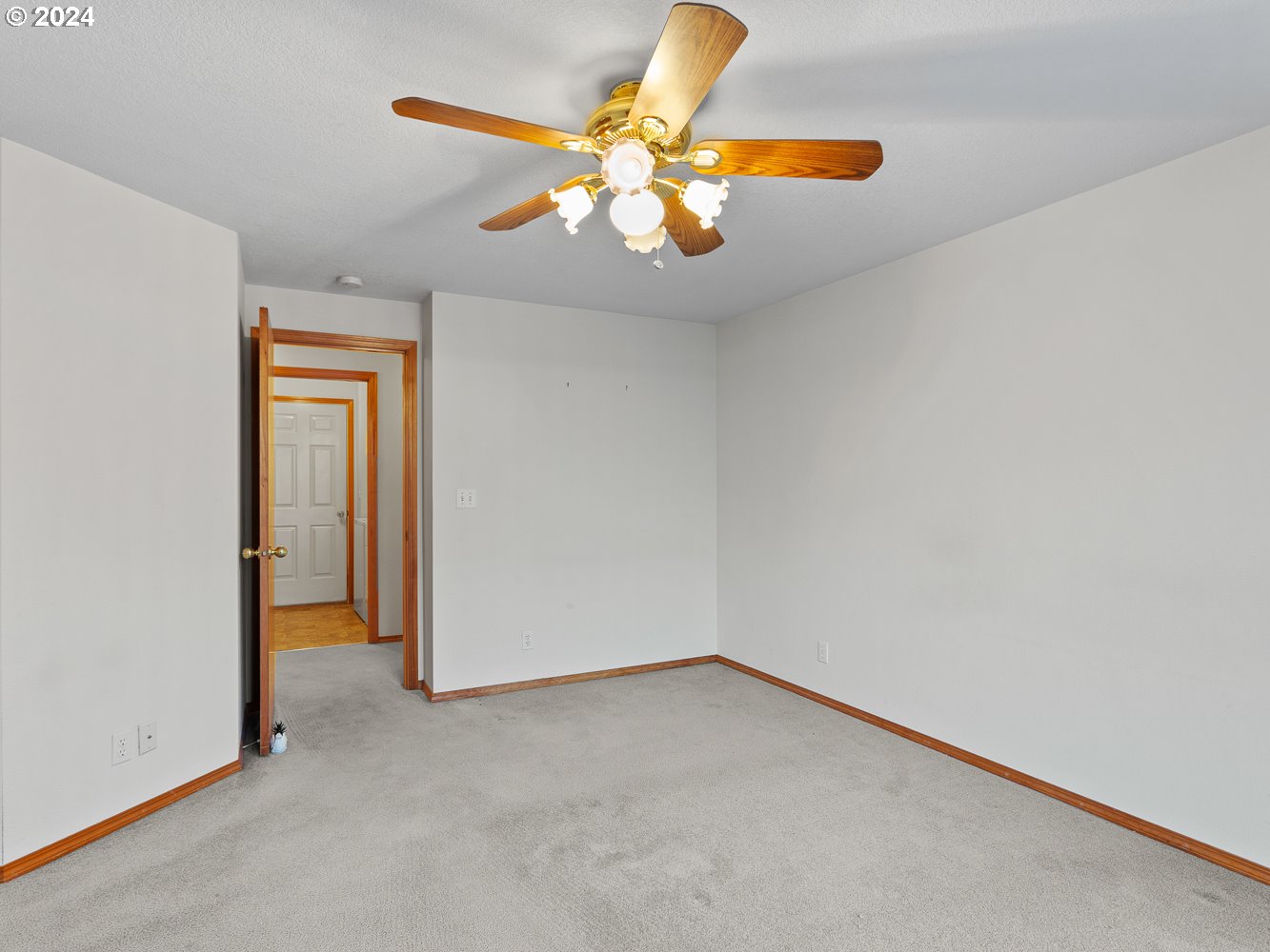 1180 North 1st Avenue Ridgefield, WA 98642 - Photo 23 of 48 an empty room with a chandelier fan and a window