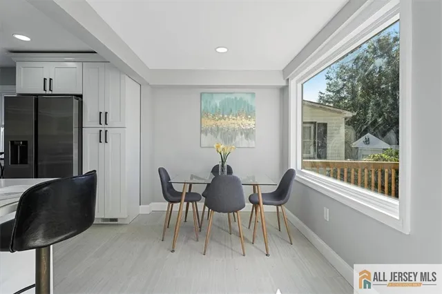 a kitchen with stainless steel appliances kitchen island granite countertop a refrigerator and a sink