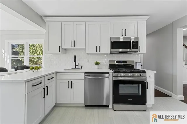 a bathroom with a sink a toilet and a window