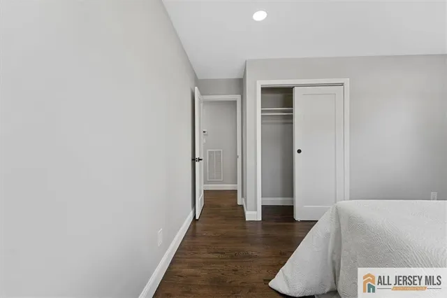 a spacious bedroom with a bed and a window