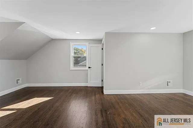 a view of an empty room and wooden floor