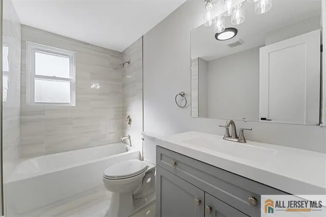 a bathroom with a toilet and a bath tub