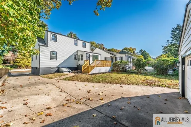 a view of a house with a yard and potted plants