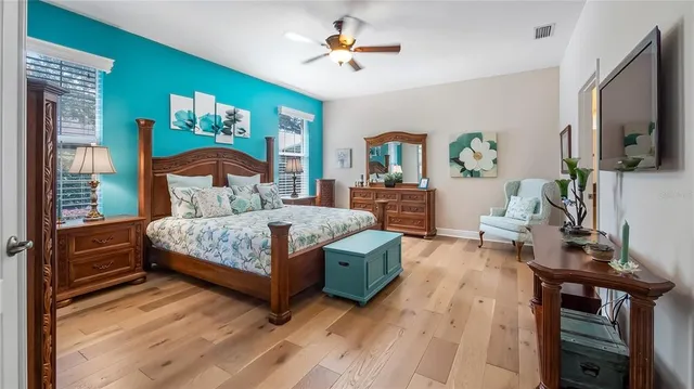 a bedroom with a bed and a chandelier