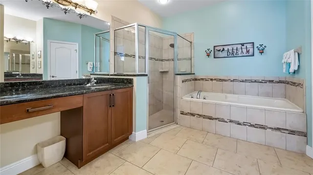 a bathroom with a granite countertop sink a toilet and bathtub