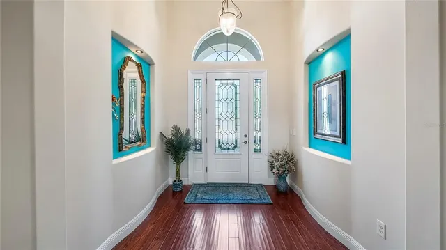 a front view of a house with garden and furniture