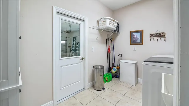 a hallway with a stove a washer and dryer