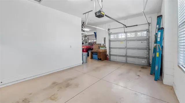 a utility room with lot of items and white cabinets